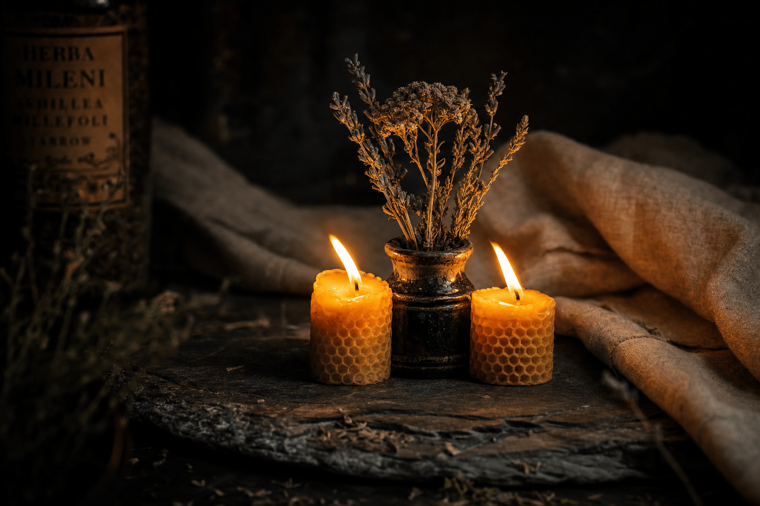 Two candles leaning together beside a botanical ceramic vessel, a polyvagal theory connection still life